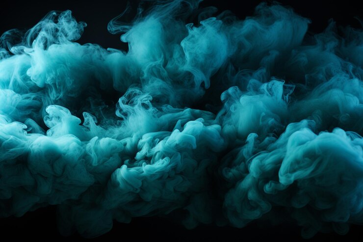 Photo des nuages de fumée turquoise s'étendent sur un fond noir.