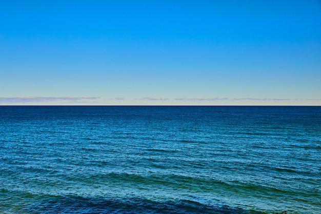 Océan ou lac avec de douces vagues bleues et vertes à midi