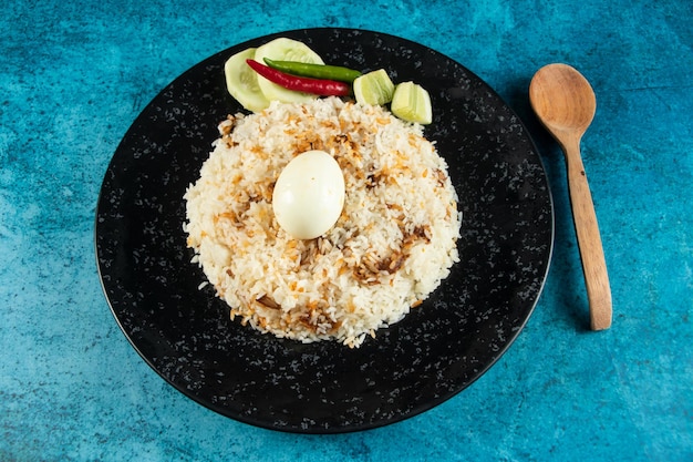 Photo oeuf épicé pulao polao biryani mandi kacchi avec oeuf et salade servis dans un plat isolé sur la vue de dessus de table de la cuisine indienne