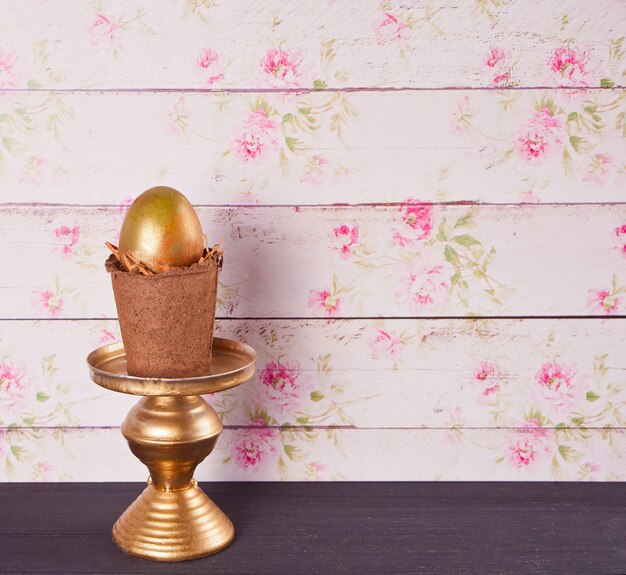 Photo oeuf d'or dans un pot sur la table