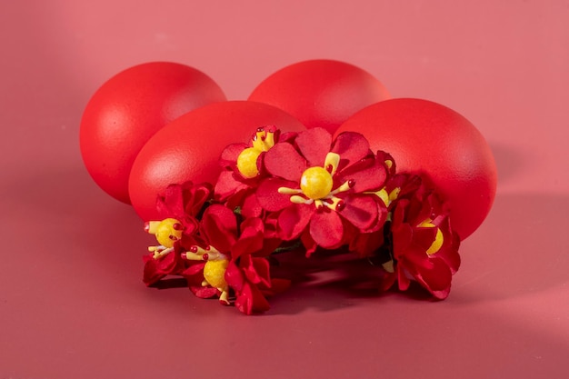 Des œufs colorés symbolisant Pâques sur un fond coloré et des fleurs