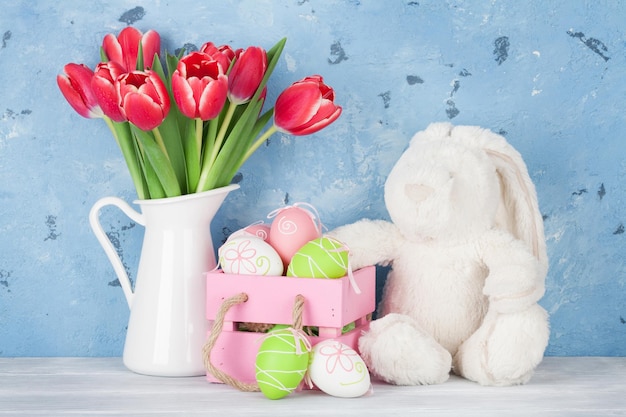 Oeufs de fleurs de tulipe rouge et jouet de lapin de pâques