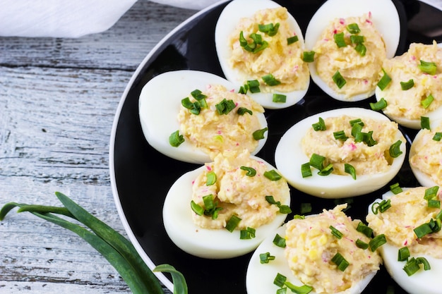 Oeufs maison farcis de fromage et de crabe garnis d'oignons verts