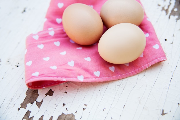 Oeufs sur nappe sur table en bois