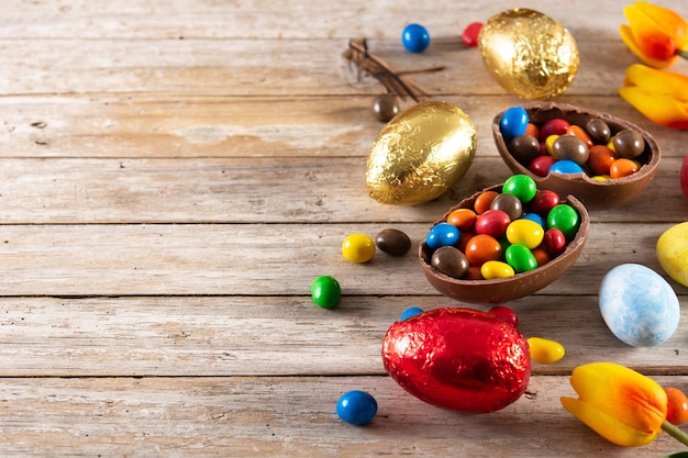 Oeufs de Pâques en chocolat colorés sur table en bois