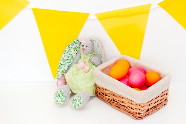 Oeufs de Pâques lapins mignons sont dans le panier. Joyeuses Pâques. oeufs peints sur une surface claire