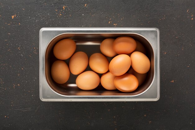 Oeufs de poulet et de caille frais dans un plateau en fer-blanc. Nature morte. Vue d'en-haut. Photographie culinaire pour l'intérieur