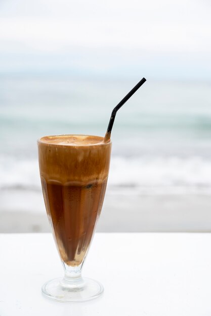 ? Offee Boire Avec De La Mousse Et De La Paille Sur Un Tableau Blanc Avec Mer