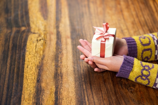 Photo offrez un cadeau sur fond en bois, vue de dessus