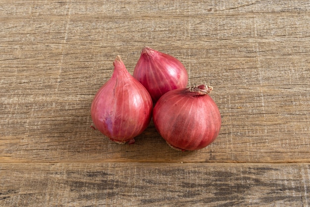 Oignon rouge sur planche de bois minable.