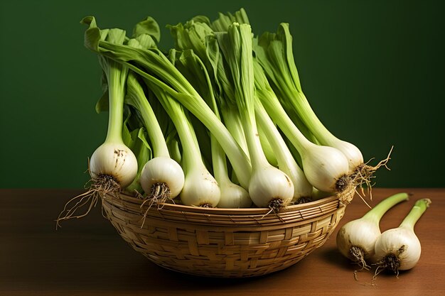 oignons verts dans une table de cuisine derrière fond vert concept de nourriture végétalienne