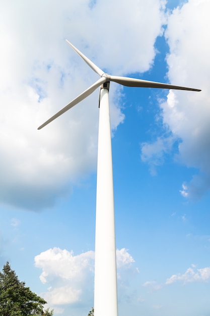 Éolienne contre un ciel bleu nuageux