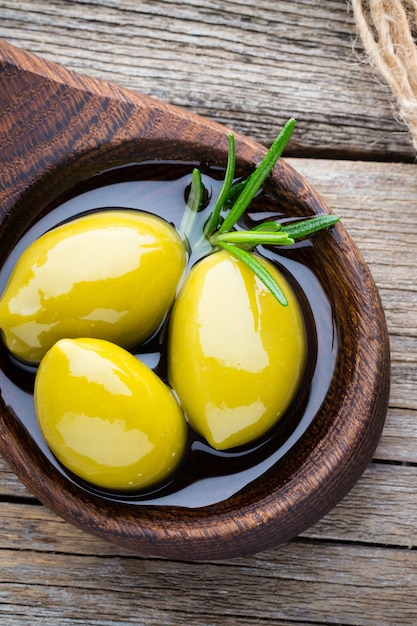 Olives fraîches et fond gris. Olives dans un bol et cuillère.