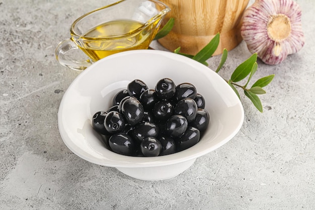 Olives noires avec huile et branche