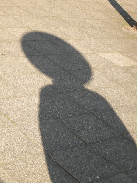 L'ombre d'un homme sur la passerelle pendant une journée ensoleillée