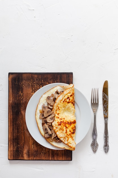 Omelette aux champignons sur une planche de bois