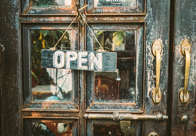 Photo open sign hanging on vintage door