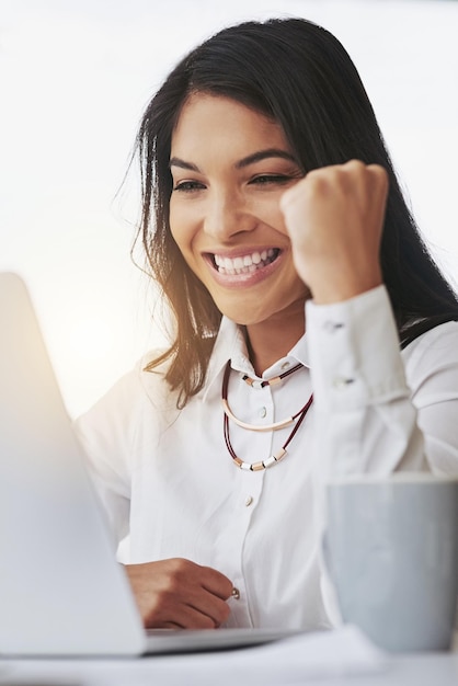 Ordinateur portable gagnant et femme d'affaires avec une pompe de poing pour le succès en ligne du marché boursier et de la célébration de la cible Gagnant oui et professionnel enthousiaste à la loterie de promotion par e-mail ou bonne nouvelle