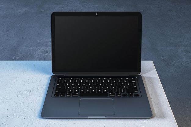 Un ordinateur portable moderne avec un écran vide sur une table en béton Rendering 3D