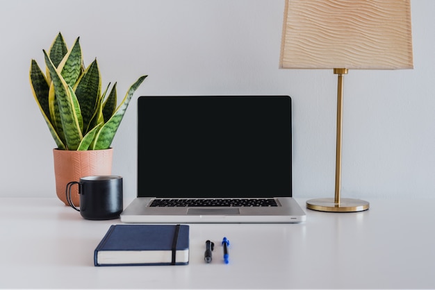 Ordinateur portable avec ordinateur portable et plante sur une table