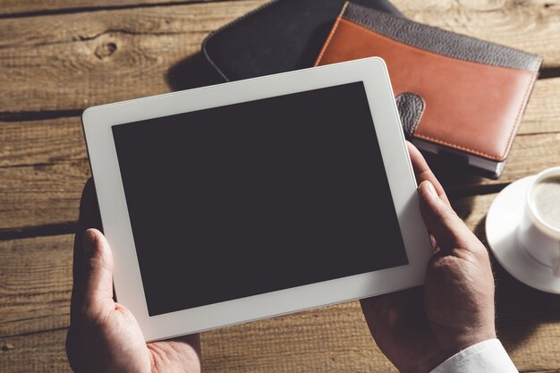 Photo ordinateur tablette avec écran isolé dans les mains des hommes.