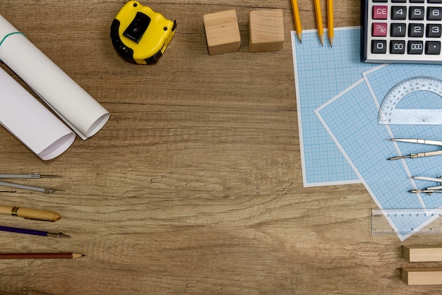 Outils de dessin avec du papier millimétré sur une table en bois