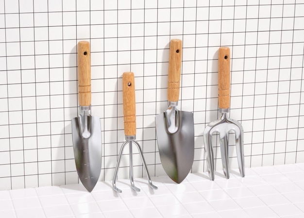 Des outils de jardinage en métal avec des poignées en bois se tiennent en rangée. Petite fourchette de jardin, pelle, râteau et cuillère.