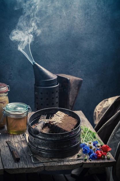 Outils rouillés pour l'apiculture en atelier avec du miel