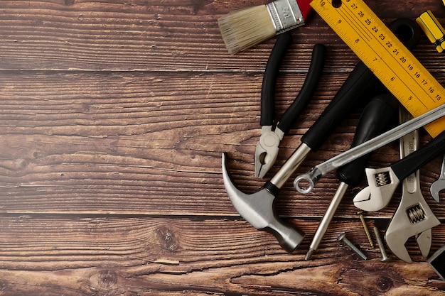 Outils de travailleur de la construction sur fond de table en bois.