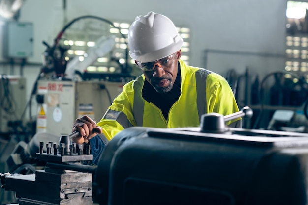 Ouvrier ou ingénieur d'usine fait un travail de machine dans un atelier de fabrication adepte