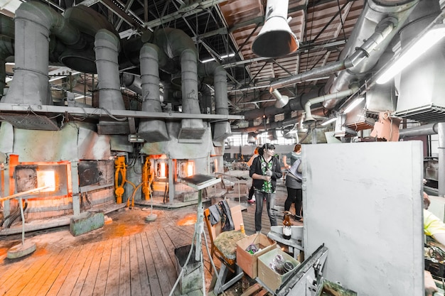 Photo ouvrier verrier travaillant avec de l'équipement industriel dans une usine