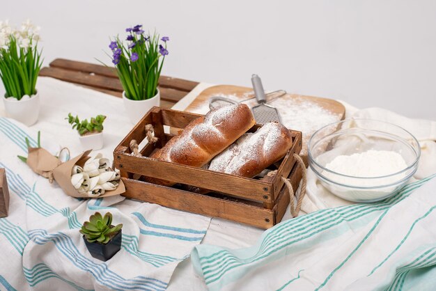 Photo pain sur le décor de table à partir de fleurs et tissus couverts de farine dans la cuisinexa