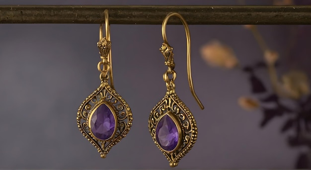 Photo une paire de boucles d'oreilles avec une pierre violette et une chaîne d'or