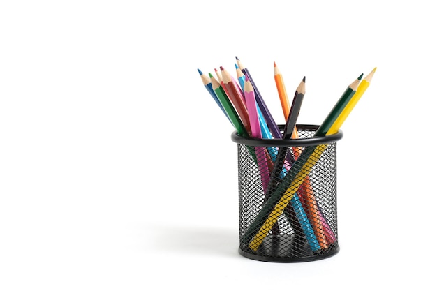 Panier de bureau avec des crayons de couleur sur fond blanc.