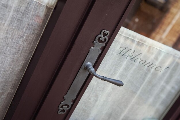 Panneau de bienvenue sur une porte en verre vintage