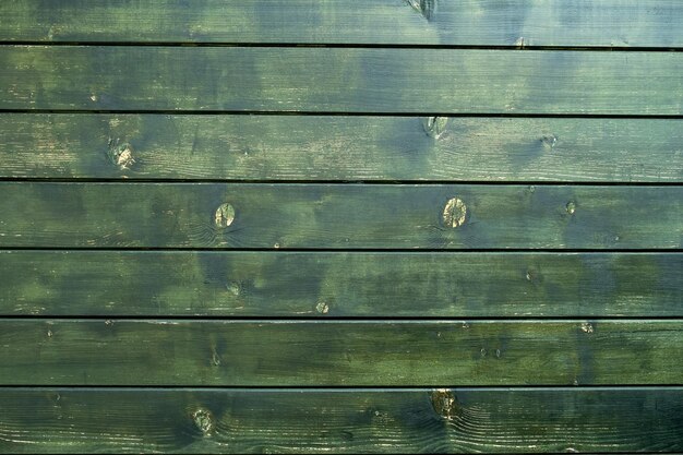 Un panneau de bois vert avec le mot bois dessus