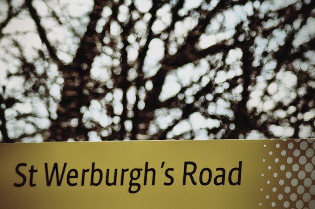 Photo un panneau de signalisation jaune contre les arbres