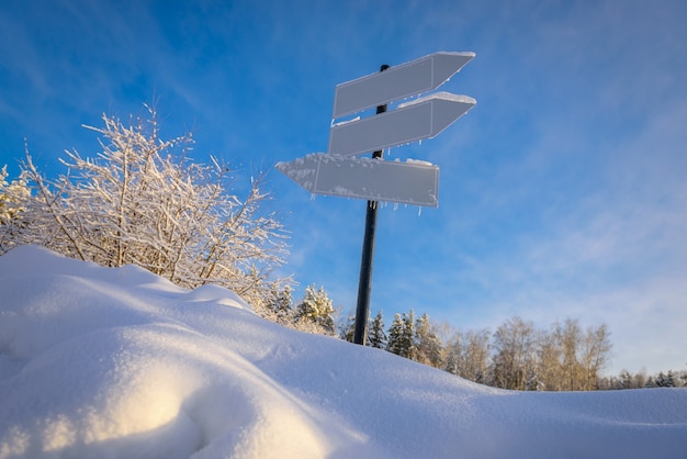 Panneau vide avec trois flèches blanches contre beau ciel bleu en journée ensoleillée gelée