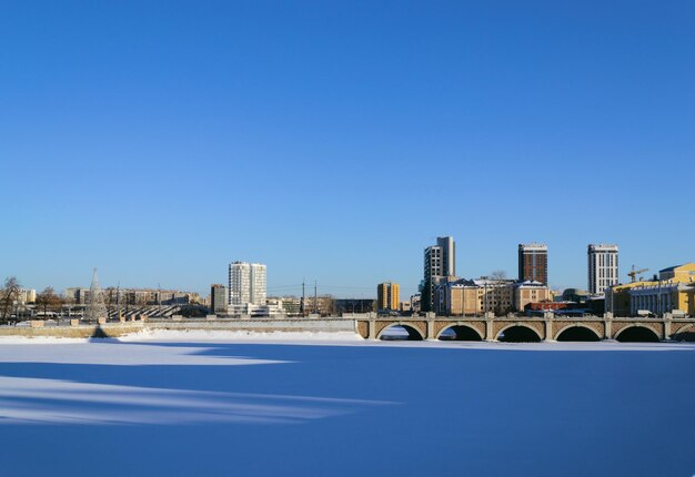 Panorama de la ville, sur laquelle la rivière gelée, le misi et les immeubles résidentiels