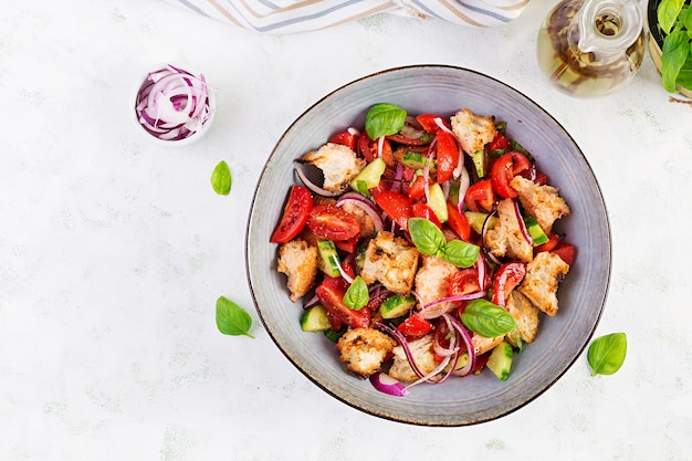 Panzanella toscane, salade italienne traditionnelle avec tomates et pain. Salade panzanella végétarienne. Nourriture saine méditerranéenne. Vue de dessus, espace de copie