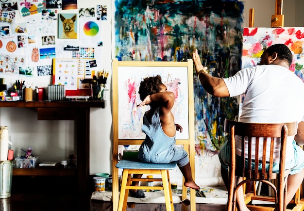 Photo papa artiste d'ascendance africaine donnant à son enfant un high five