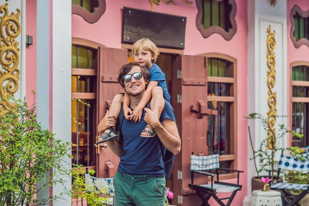 Papa et fils sont des touristes dans la rue dans le style rom de style portugais à Phuket Town. Aussi appelé Chinatown ou la vieille ville