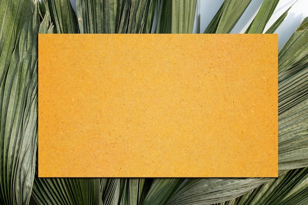 Papier brun vierge sur les feuilles sèches de palmiers tropicaux. Copier l'espace