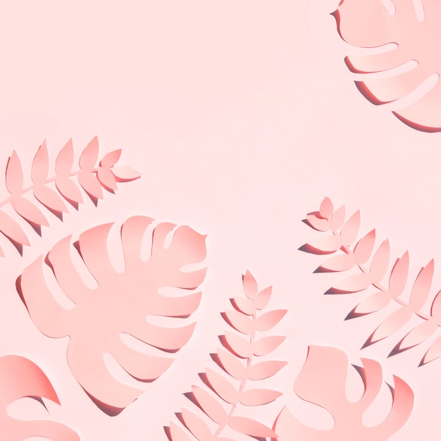 Papier coupé style des feuilles dans les tons roses
