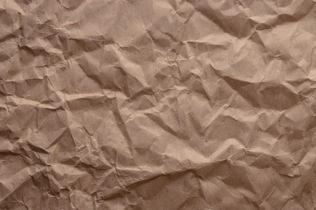 Papier froissé. feuille de papier cartonné brun. texture haute résolution détaillée. fond abstrait pour papier peint.