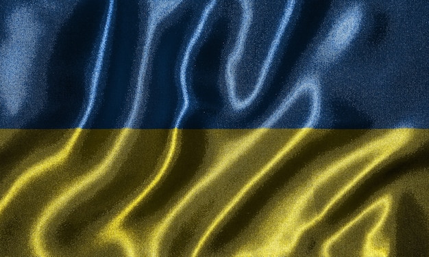 Papier peint par le drapeau de l&#39;Ukraine et agitant le drapeau par le tissu.