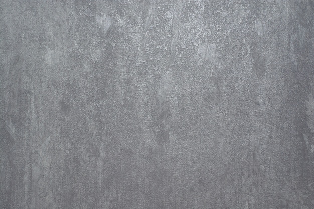 Papier peint vinyle gris imitation béton.