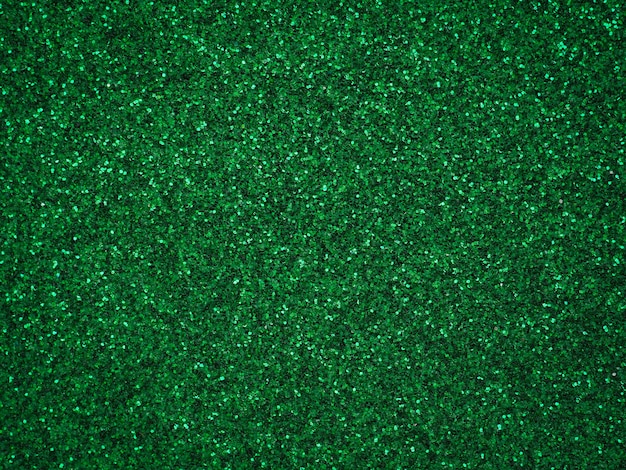 Un papier vert pailleté. Texture abstraite de bokeh léger paillettes d'argent