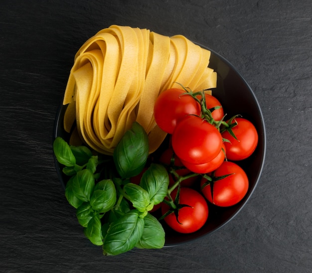 Pappardelle de pâtes italiennes jaunes crues, fettuccine ou vue de dessus de tagliatelles.