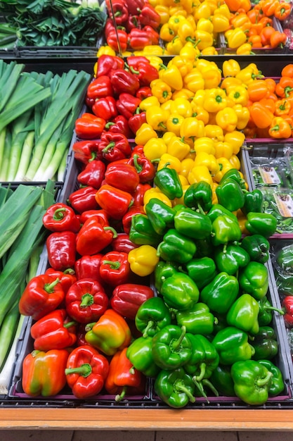 Paprika vert, rouge et jaune sur les étagères des magasins